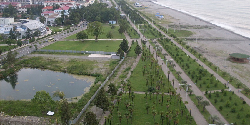 Stunning waterfront promenade with gardens, sculptures, and coastal views