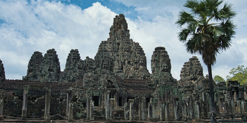 An image showing Bayon Temple, a destination in Siem Reap, with its stone faces.