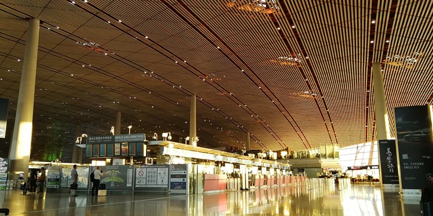 Passengers walking and checking in at Beijing Capital International Airport Terminal 3
