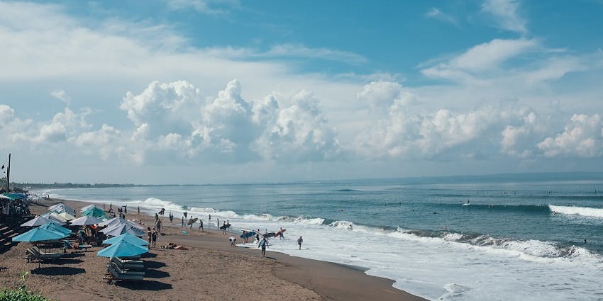 An image of surfers and beach lovers enjoying the scenic coastline and waves of Berawa
