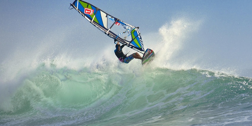An image showing a windsurfer having adventure amidst the marine waters.