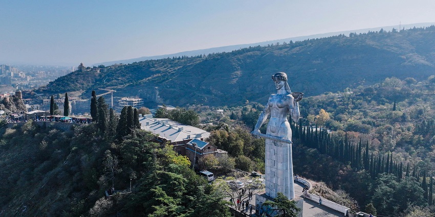 Scenic view of Mother of Georgia Statue surrounded by stunning architecture and mountains