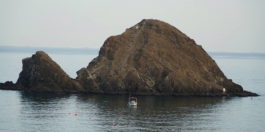Snoopy Island, a rocky island off the coast of Fujairah, UAE, with calm blue waters