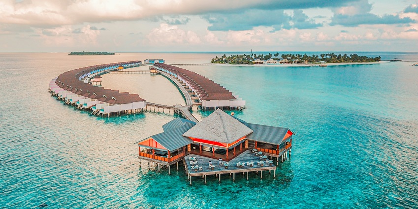 Crystal-clear waters surround Male Island under sunny skies from November to April.
