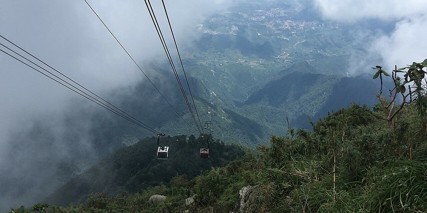 Spectacular scenery of Fansipan Mountain shrouded in clouds with a clear blue sky