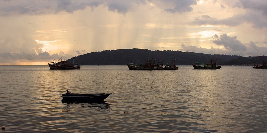 An image of a beautiful waterfront with diverse architectural styles, docked boats