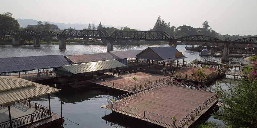 A sunny day in Kanchanaburi, with clear blue skies and green landscapes.