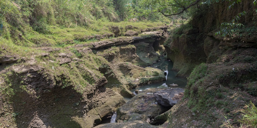 Beautiful view of Davis Falls, Nepal, with cascading waters disappearing into caves.