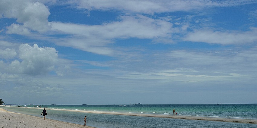 Hua Hin Beach, a coastal area , with people walking along the shore