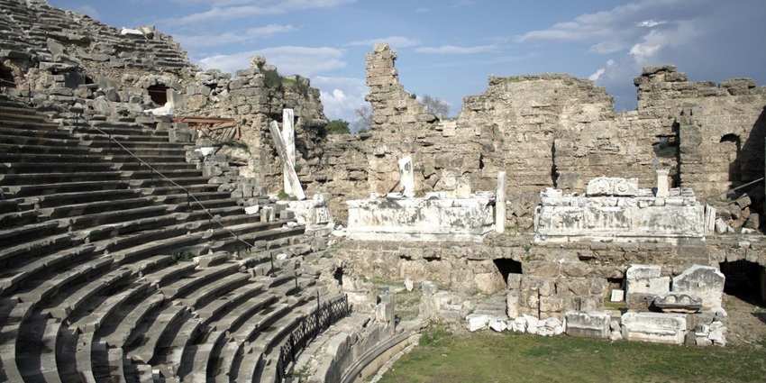 A picture of Aspendos Theatre bathed in golden light during the early evening hours.