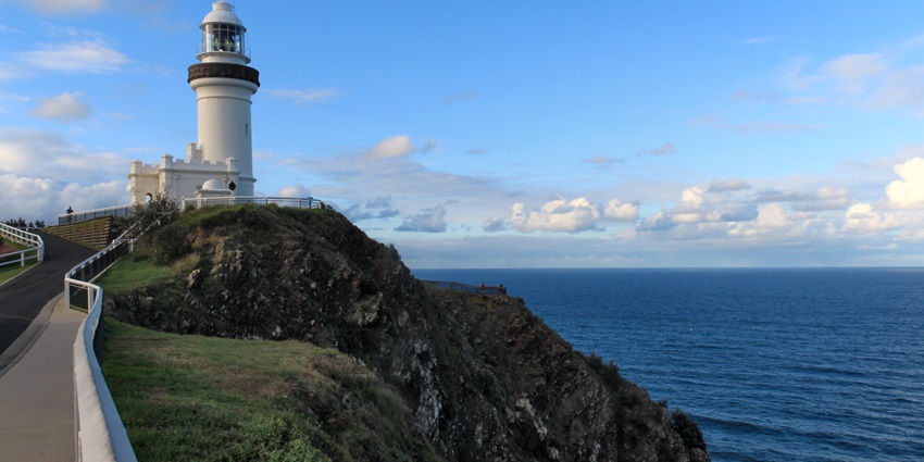 Image of the bay, featuring the lighthouse, with the clear blue sky in the background