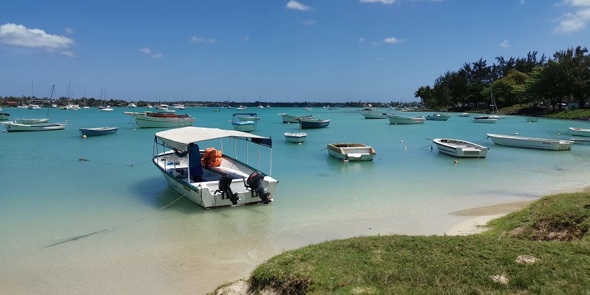 View of the turquoise shores of this village with empty boats alongside