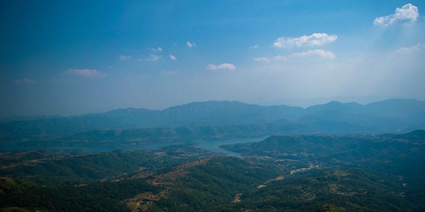 An aerial view of the rugged geography near Bhudargad Fort, showcasing the vast landscape.