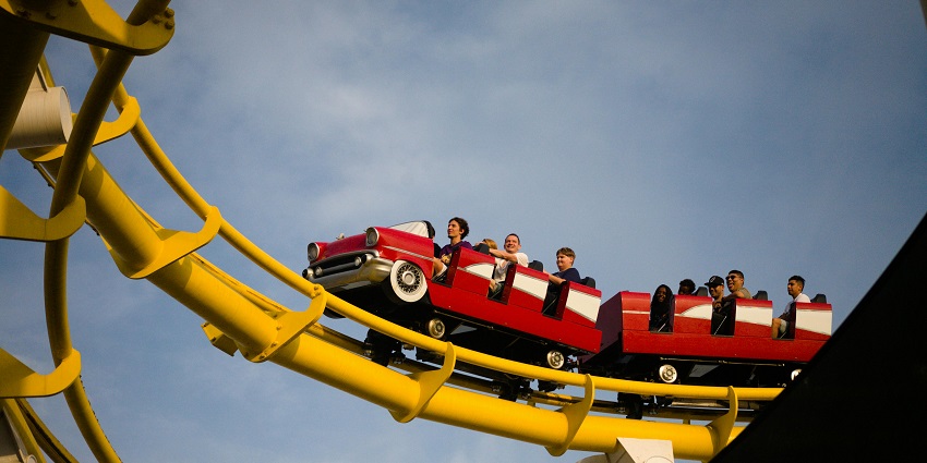 People enjoying a thrilling rollercoaster ride at a water park near Kurukshetra on a bright sunny day.