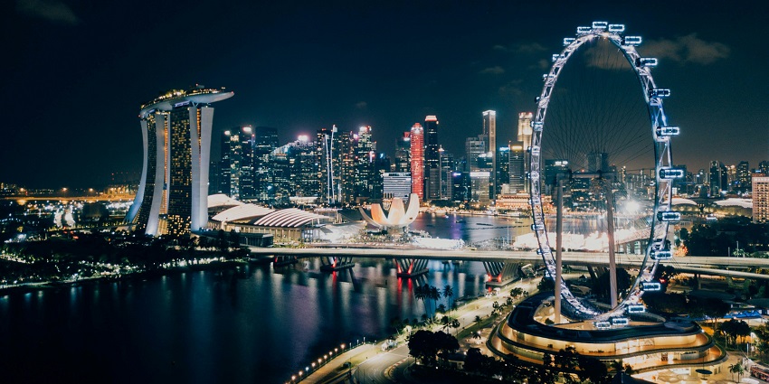 View of the Singapore flyer at night, adorned with city lights
