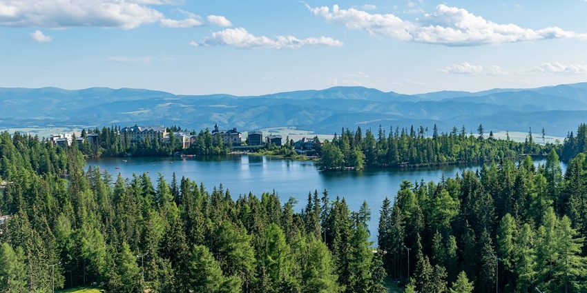 An image of calm and scenic view of Bhagtali Lake surrounded by greenery.