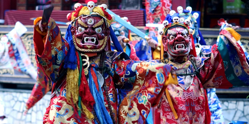 People dressed in vibrant marks for the festival celebrations
