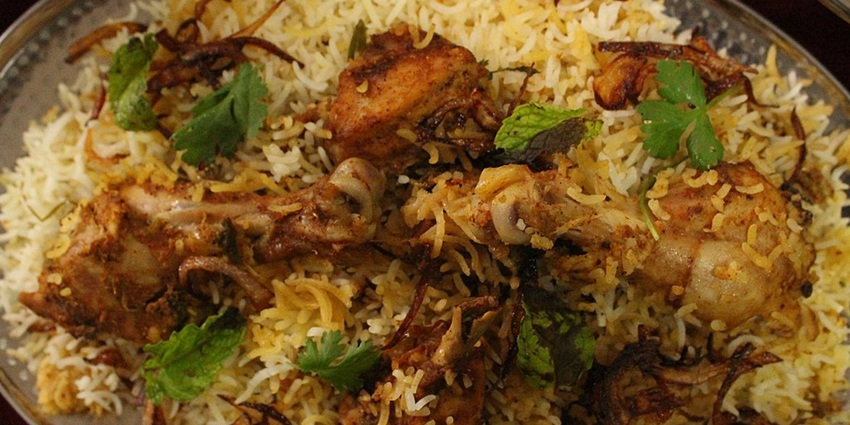 Image of Hyderabadi Biryani, one of the best food in India, served with raita
