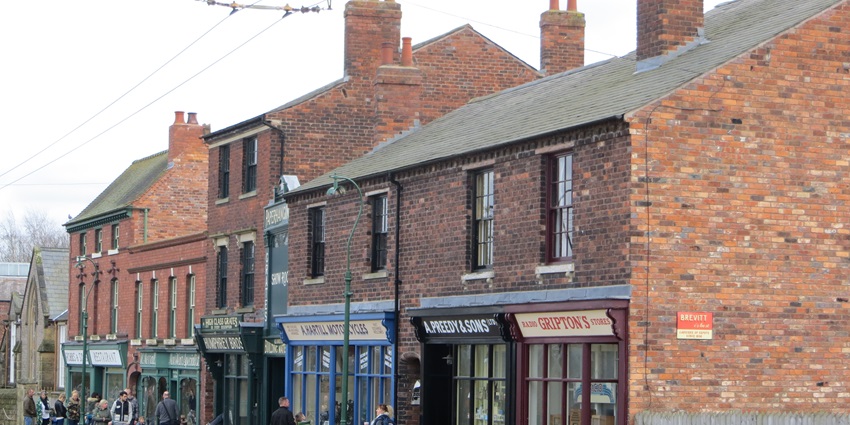 Visitors walking on the artificial road and exploring the Black Country Living Museum.