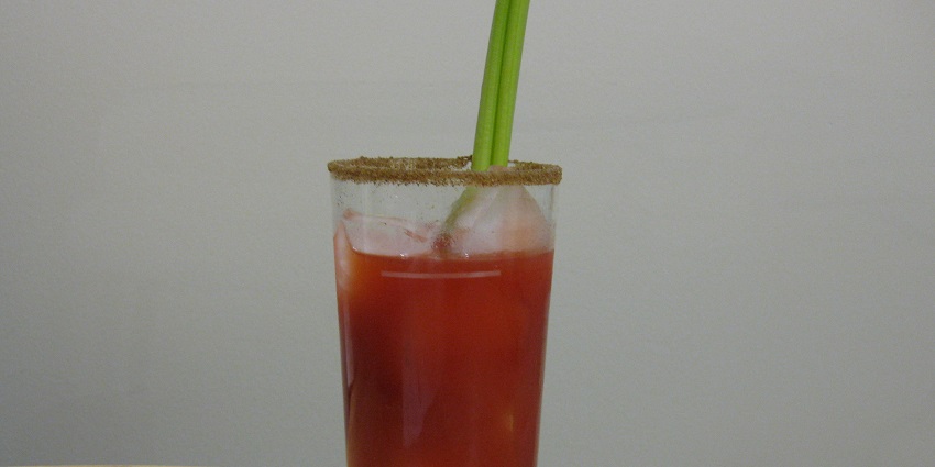 Bloody Caesars with vodka, clamato juice, spices, and a salted rim garnish.