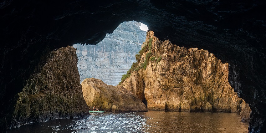 Experience the enchanting charm of crystal-clear waters flowing among famous caves.
