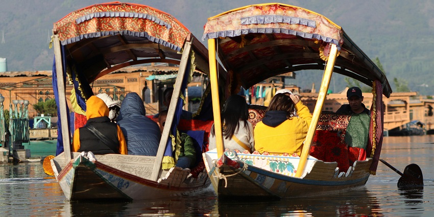 Shikara boat gliding across the Wular Lake, the Biggest Fresh Water Lake in India.