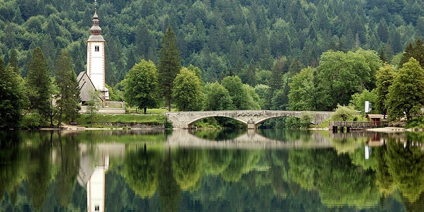 Pristine Alpine Lake is surrounded by towering peaks, offering hiking, kayaking, and peaceful nature escapes.