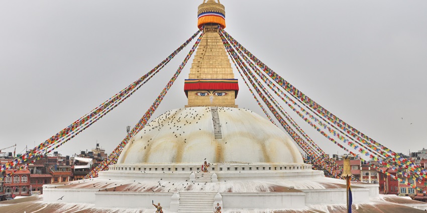 Boudhanath Stupa in Kathmandu with vast prayer wheels and serene surroundings.