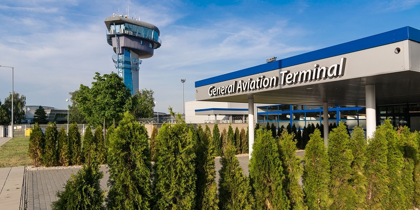 The General Aviation Terminal building of the Bratislava Airport with ATC Tower in the background.