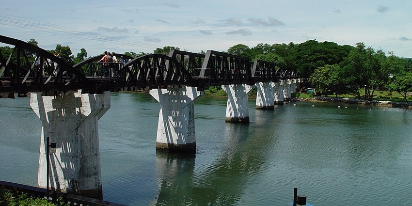 The Bridge over the River Kwai in Kanchanaburi, featuring original and replaced spans
