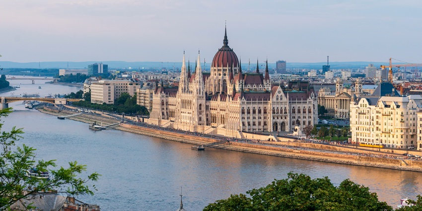 A breathtaking view of the Hungarian Parliament Building with fireworks in the night sky.