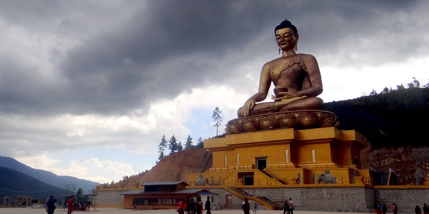 The giant golden Buddha Dordenma Statue sitting on a hilltop overlooking Chorten Bhutan.