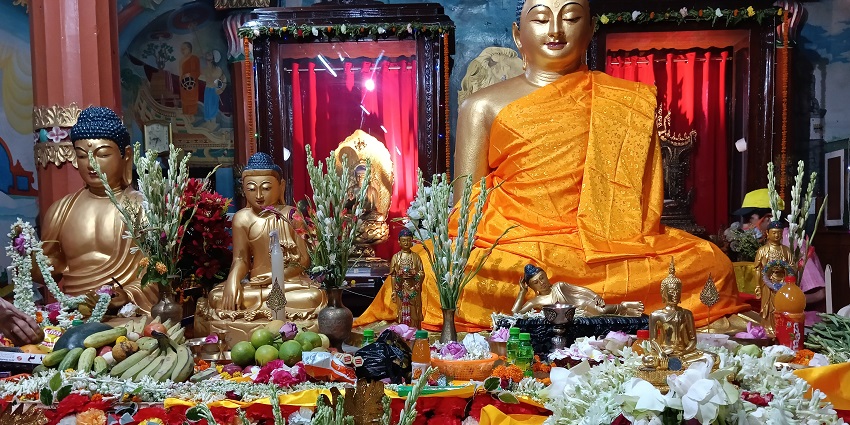 An Indonesian kid performing rituals during Buddha Purnima, a religious day for Buddhists.