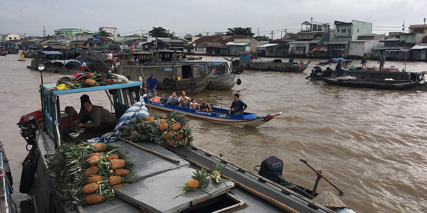 An image showing Cai Rang Floating Market, one of the famous places to visit in Mekong Delta.