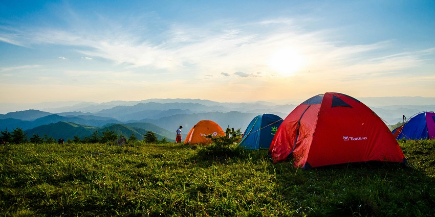 A glimpse of a camp nestled on the lush green manicured grounds of Himachal.