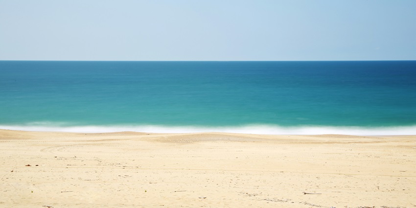 A serene view of the Can Tho Beach featuring pristine golden sands and azure waters.