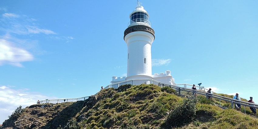 The iconic Cape Byron Lighthouse is perched on a cliff with panoramic ocean views.