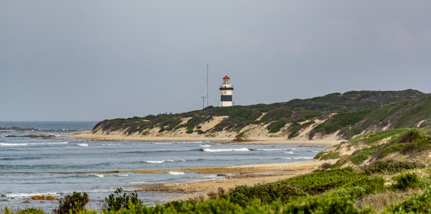An image of a lighthouse with a striped design, at the Cape Recife Nature Reserve.