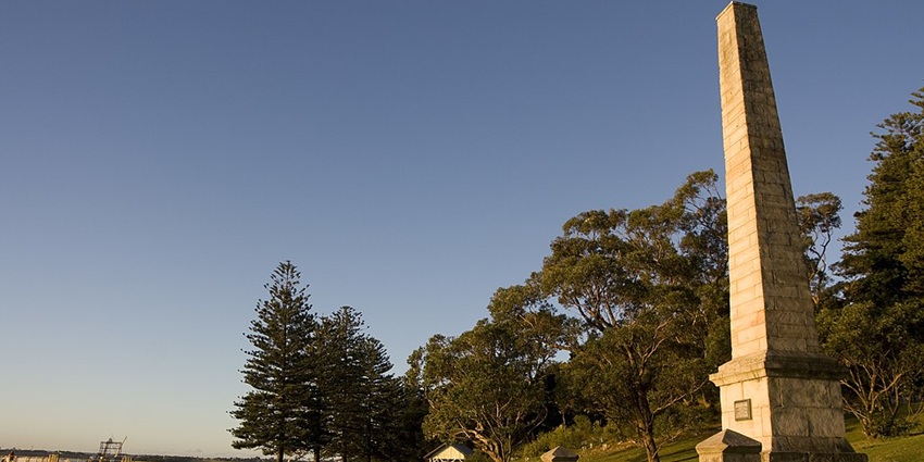 The view of the monument in Captain Cook's Landing Place, surrounded by greenery.
