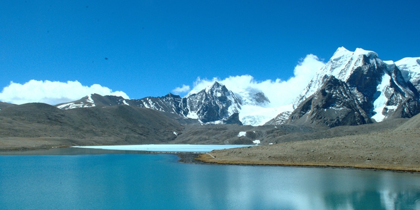 A photographer taking inside the stunning snow-crammed landscapes surrounding Gurudongmar Lake in December.