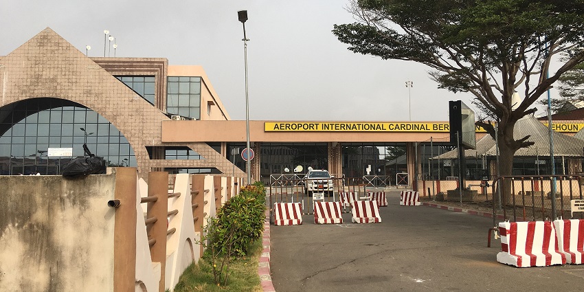 Entryway with a sign that says Aeroport International Cardinal Bernardin Gantin in Benin.