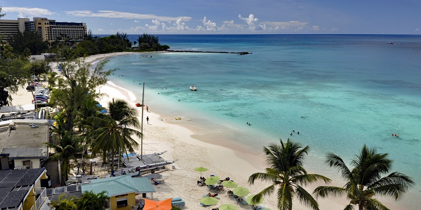 An image of the white sandy beach of Carlisle Bay, one of the top places to visit in Barbados.