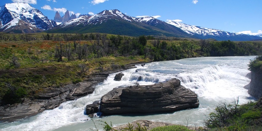 Discover this stunning Patagonian waterfall framed by the dramatic peaks of Torres del Paine.