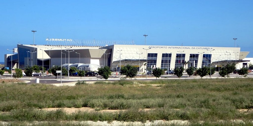 Terminal building of the International Catumbela Airport beyond the green grassy area.