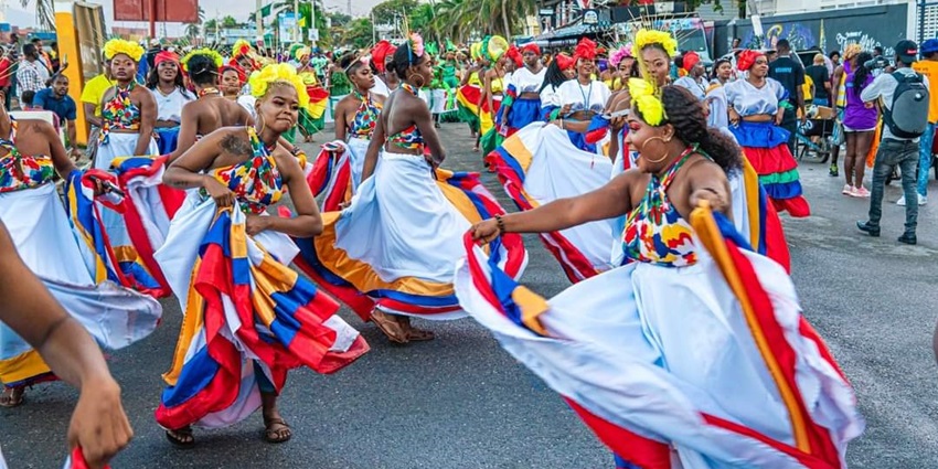 An image of a vibrant parade during Haiti’s Carnival, showcasing colourful costumes and lively music.