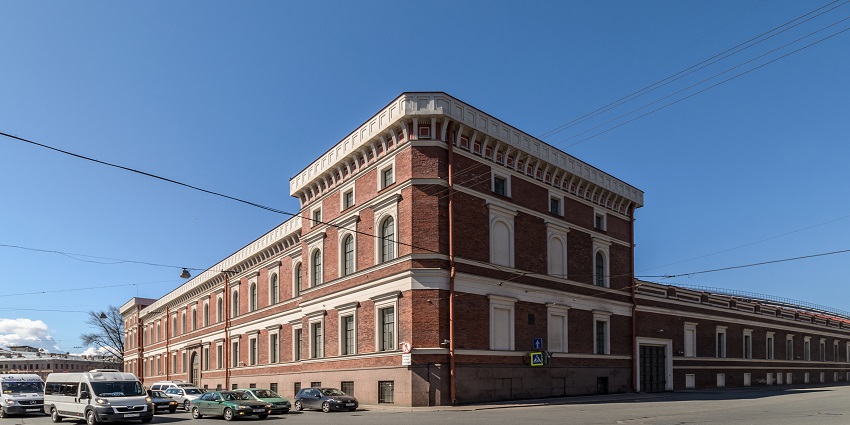 An image of the Central Naval Museum in Saint Petersburg, with white trim, arched windows, and parked cars nearby.
