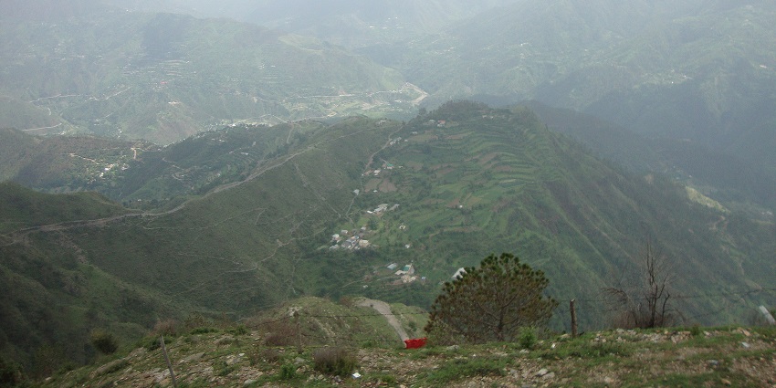 Chail hill station from the top of a hill with buildings and roads below in greenery