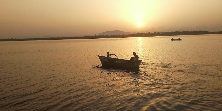 An image of Chandlai Lake, a lake in Jaipur, with calm waters and migratory birds in a serene setting