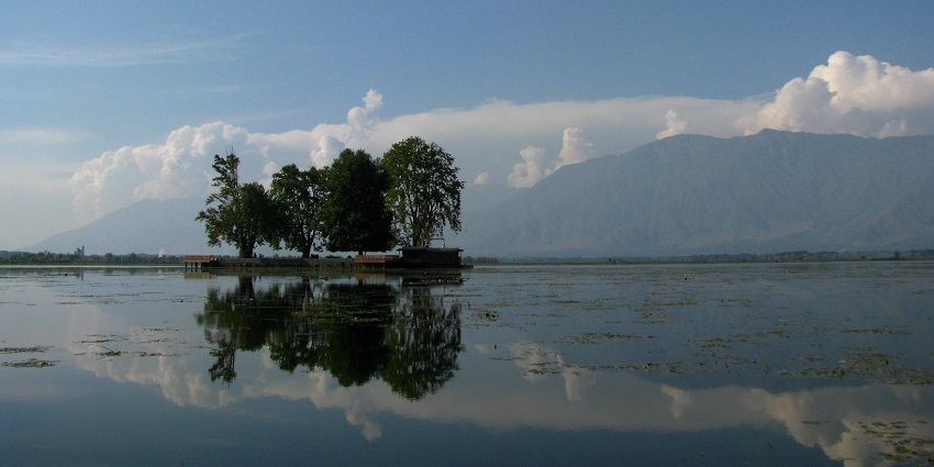 Char chinar island in Dal Lake with four chinar trees, a large water body and distant hills