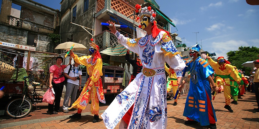 An image of participants performing a parade during Cheung Chau Bun Festival in May.